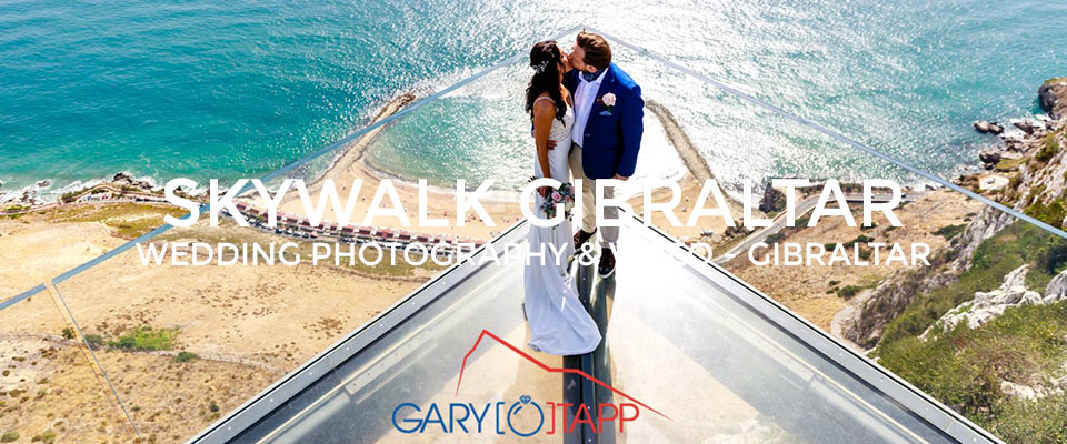 Bride and Groom standing on the Skywalk Gibraltar for thier wedding photos